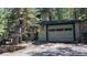 Charming log cabin with a garage surrounded by mature trees, offering a rustic and private setting at 30094 Upper Bear Creek Rd, Evergreen, CO 80439