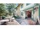 Inviting home exterior featuring a stone patio, rustic accents, and a welcoming, forest vibe at 30094 Upper Bear Creek Rd, Evergreen, CO 80439
