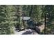 Charming home nestled among trees with stone accents and an attached garage for a secluded, woodsy feel at 30094 Upper Bear Creek Rd, Evergreen, CO 80439