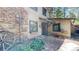 Log cabin featuring stone accents, outdoor seating, and a charming rustic setting at 30094 Upper Bear Creek Rd, Evergreen, CO 80439