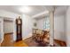 Hallway with an antique grandfather clock, rocking chair and staircase with wooden log trim at 30094 Upper Bear Creek Rd, Evergreen, CO 80439