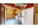 Cozy kitchen with wood walls, charming vintage cabinets, and modern appliances for a rustic feel at 30094 Upper Bear Creek Rd, Evergreen, CO 80439