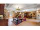 Spacious living room with wood-paneled walls, beamed ceilings, and rustic decor creating a cozy ambiance at 30094 Upper Bear Creek Rd, Evergreen, CO 80439