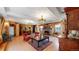 Warm and inviting open floor plan featuring wood walls, a stone fireplace, and vintage accents at 30094 Upper Bear Creek Rd, Evergreen, CO 80439
