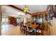 Spacious living room with vintage lighting, wood paneled walls, and an open floor plan at 30094 Upper Bear Creek Rd, Evergreen, CO 80439