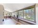 Bright sun room with large windows offering views of surrounding trees at 30094 Upper Bear Creek Rd, Evergreen, CO 80439