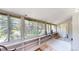 Bright sun room with large windows offering views of surrounding trees at 30094 Upper Bear Creek Rd, Evergreen, CO 80439