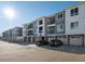 Modern apartment building with attached garages and ample parking at 6153 N Ceylon St # 306, Denver, CO 80249