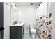 Bathroom featuring a modern vanity, floral shower curtain, decorative mirror, and neutral colors at 960 N Pennsylvania St # 6, Denver, CO 80203