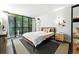 Cozy bedroom featuring large windows, hardwood floors, neutral decor, and modern accents at 960 N Pennsylvania St # 6, Denver, CO 80203