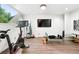 Bright home gym with hardwood floors, large windows, and an array of exercise equipment at 960 N Pennsylvania St # 6, Denver, CO 80203