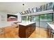 Sunlit kitchen featuring a spacious island with breakfast bar, stainless steel appliances, and hardwood floors at 960 N Pennsylvania St # 6, Denver, CO 80203