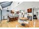 Open kitchen featuring hardwood floors, stainless steel appliances, island with bar seating, and modern lighting at 960 N Pennsylvania St # 6, Denver, CO 80203
