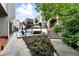 Exterior view of a condo complex with a pool, patio furniture, and flower beds at 960 N Pennsylvania St # 6, Denver, CO 80203