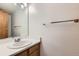 This cozy bathroom offers a single sink vanity and a well lit mirror at 11580 Depew Ct, Westminster, CO 80020