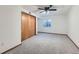 Bedroom featuring neutral carpet, fan, closet, and a window allowing natural light at 11580 Depew Ct, Westminster, CO 80020