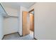 View of a walk-in closet with carpet, ample hanging space, and an access door at 11580 Depew Ct, Westminster, CO 80020