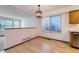 Cozy dining area featuring hardwood floors, modern lighting, and large windows with backyard views at 11580 Depew Ct, Westminster, CO 80020