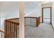 Upstairs hallway featuring carpet, a wooden railing and an open doorway at 11580 Depew Ct, Westminster, CO 80020