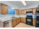 Well-lit kitchen featuring light wood cabinets, stainless steel appliances, and a functional layout at 11580 Depew Ct, Westminster, CO 80020