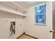 Laundry room with washer hookups, shelves, a window, and wood-look floors at 11580 Depew Ct, Westminster, CO 80020