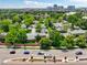 Aerial view of a neighborhood with well-manicured lawns, walkways, and mature trees along a street at 8730 E Roundtree Ave, Greenwood Village, CO 80111