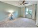 Spacious bedroom featuring a ceiling fan, large window, and neutral carpeting at 8730 E Roundtree Ave, Greenwood Village, CO 80111