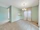 Dining room with plush carpeting, a chandelier and view to other parts of the house at 8730 E Roundtree Ave, Greenwood Village, CO 80111