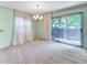 Dining room with plush carpeting, a chandelier, view to the backyard through sliding door at 8730 E Roundtree Ave, Greenwood Village, CO 80111