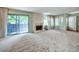 Well-lit living room featuring plush carpeting, a white fireplace, and sliding doors at 8730 E Roundtree Ave, Greenwood Village, CO 80111