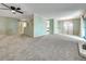 Spacious living room with fresh paint, plush carpeting, and a ceiling fan at 8730 E Roundtree Ave, Greenwood Village, CO 80111