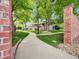 Street view of the home showing the inviting walkway and mature trees at 8730 E Roundtree Ave, Greenwood Village, CO 80111
