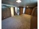 Carpeted basement with wood paneled walls and multiple rooms at 588 Empire St, Aurora, CO 80010