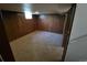 Basement room with wooden walls and carpeted floors at 588 Empire St, Aurora, CO 80010
