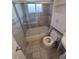 Clean bathroom with tiled shower-tub combo and glass door at 588 Empire St, Aurora, CO 80010
