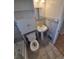 Tiled bathroom featuring tiled walls, new toilet, and pedestal sink at 588 Empire St, Aurora, CO 80010