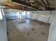 A spacious garage with an abundance of room with built-in shelves and a large door for parking at 588 Empire St, Aurora, CO 80010