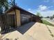 Detached garage with private driveway, access door, and fence at 588 Empire St, Aurora, CO 80010