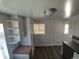 A kitchen featuring white cabinets, laminate countertops, and laminate floors at 588 Empire St, Aurora, CO 80010