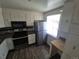 A kitchen featuring white cabinets, laminate countertops, and stainless steel appliances at 588 Empire St, Aurora, CO 80010
