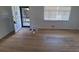 Bright living room with hardwood floors, an open front door, and a window with blinds at 588 Empire St, Aurora, CO 80010