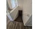A staircase leading down into the basement with clean white walls and a wooden laminate floor at 588 Empire St, Aurora, CO 80010