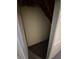 Storage area under the stairs in the home featuring painted walls and a gray floor at 588 Empire St, Aurora, CO 80010