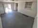 A sunroom featuring painted brick walls, concrete floor and sliding glass door to backyard at 588 Empire St, Aurora, CO 80010