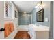 Classic bathroom featuring blue tile, modern fixtures, and a shower with sliding glass doors at 8783 S Ault Ln, Morrison, CO 80465