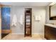 Bathroom showcasing blue tile accents, a glass-enclosed shower, and a dark wood cabinet at 8783 S Ault Ln, Morrison, CO 80465