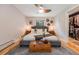 Well-lit bedroom with a decorative ceiling fan and a large bed with stylish accents at 8783 S Ault Ln, Morrison, CO 80465