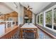 Open dining room with views, rock fireplace, lots of windows and a contemporary dining set at 8783 S Ault Ln, Morrison, CO 80465