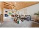 Comfortable living room showcasing wood ceiling, comfortable seating, stylish decor, and ample natural light at 8783 S Ault Ln, Morrison, CO 80465