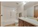 Well-lit bathroom with a tub-shower combo, single vanity and a large mirror at 13800 E Marina Dr # 112, Aurora, CO 80014
